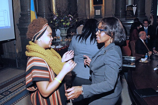 Two business women in discussion at an event.