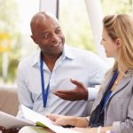 Two coaches engaged in a focused conversation.