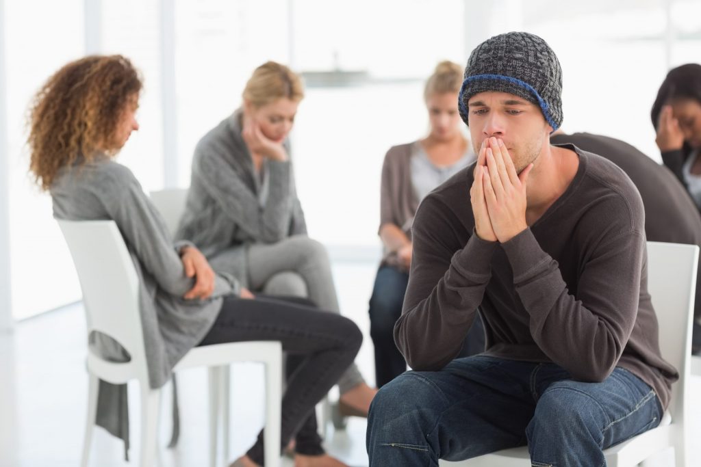 Man sharing a story in a group.